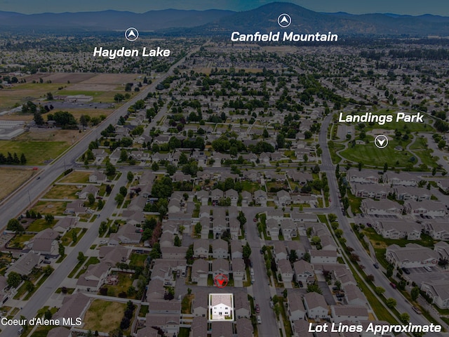 7833 N Hilliard Ct, Coeur Dalene, ID 83815 - aerial view of property's location featuring mountains and nearby suburban area