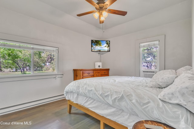 32271 N 5th Ave, Spirit Lake, ID 83869 - bedroom with a baseboard heating unit, wood finished floors, cooling unit, and ceiling fan