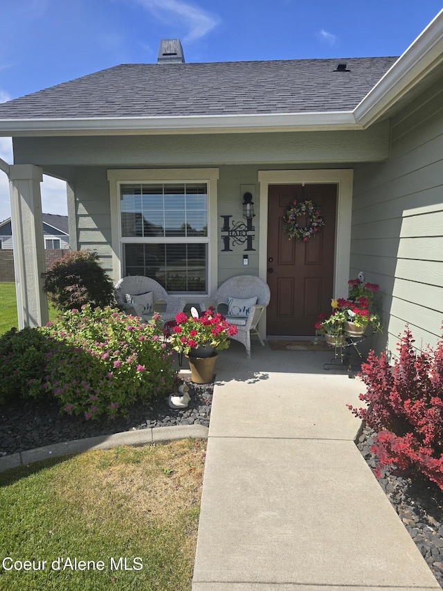7812 W Kayak Ct, Rathdrum, ID 83858 - view of exterior entry featuring covered porch and roof with shingles