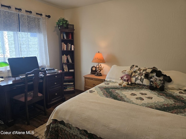 7812 W Kayak Ct, Rathdrum, ID 83858 - bedroom featuring an office area and dark wood-style flooring