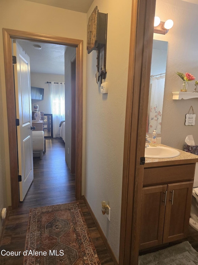 7812 W Kayak Ct, Rathdrum, ID 83858 - hallway featuring a sink and dark wood-style floors