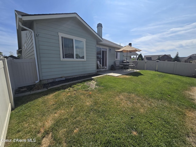 7812 W Kayak Ct, Rathdrum, ID 83858 - back of house with a patio, a fenced backyard, a chimney, and a gate