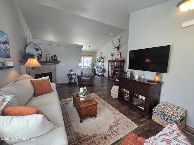 7812 W Kayak Ct, Rathdrum, ID 83858 - living area featuring wood finished floors, lofted ceiling, a fireplace, and a chandelier
