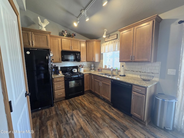7812 W Kayak Ct, Rathdrum, ID 83858 - kitchen with black appliances, lofted ceiling, decorative backsplash, dark wood finished floors, and light stone countertops