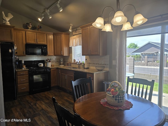 7812 W Kayak Ct, Rathdrum, ID 83858 - kitchen with black appliances, dark wood-style flooring, vaulted ceiling, backsplash, and rail lighting