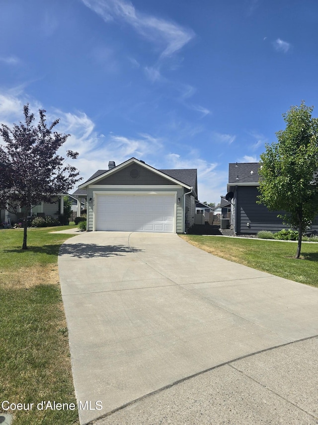 7812 W Kayak Ct, Rathdrum, ID 83858 - view of side of property featuring concrete driveway, a garage, and a lawn