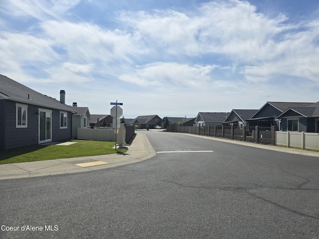 7812 W Kayak Ct, Rathdrum, ID 83858 - view of asphalt street with a residential view, traffic signs, curbs, and sidewalks