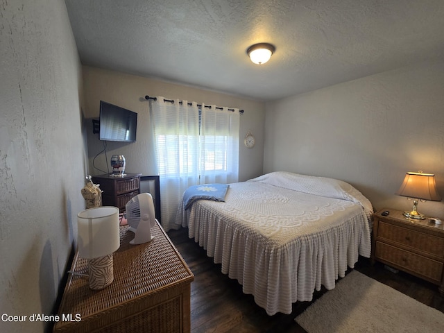 7812 W Kayak Ct, Rathdrum, ID 83858 - bedroom with wood finished floors, a textured wall, and a textured ceiling