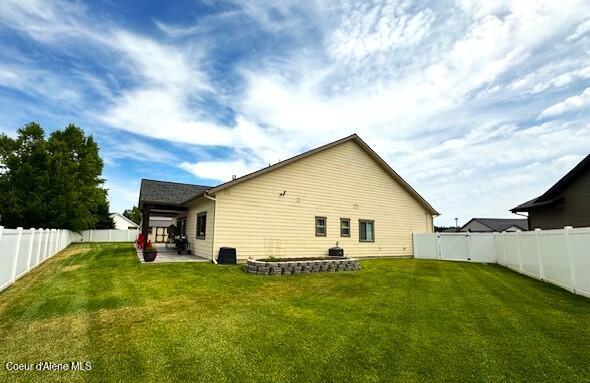 1402 W Wayward Cir, Post Falls, ID 83854 - rear view of property with a patio and a fenced backyard