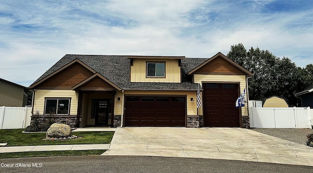 1402 W Wayward Cir, Post Falls, ID 83854 - craftsman-style house featuring stone siding, board and batten siding, driveway, a shingled roof, and a garage