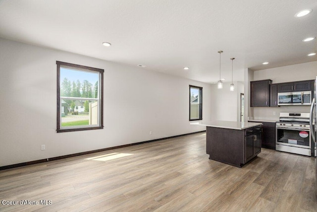 8 Potlatch Loop, Priest River, ID 83856 - kitchen with appliances with stainless steel finishes, recessed lighting, light countertops, light wood finished floors, and a kitchen island