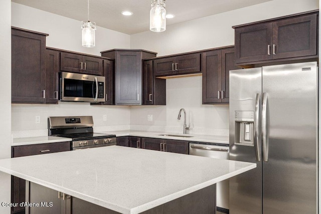 8 Potlatch Loop, Priest River, ID 83856 - kitchen featuring appliances with stainless steel finishes, dark brown cabinetry, light countertops, decorative light fixtures, and recessed lighting