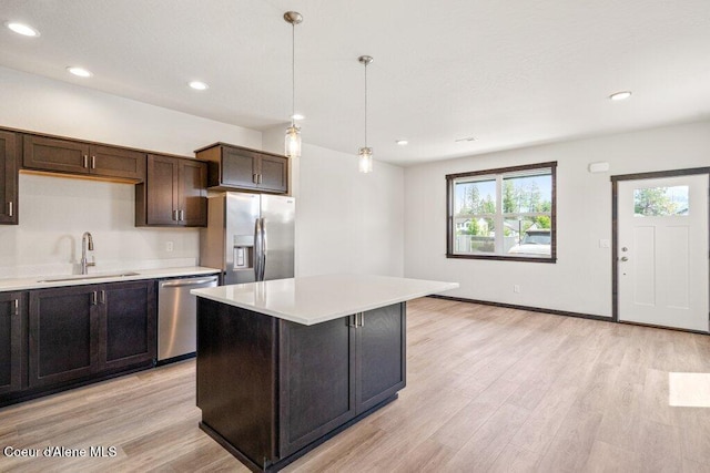 8 Potlatch Loop, Priest River, ID 83856 - kitchen with appliances with stainless steel finishes, light countertops, light wood-type flooring, decorative light fixtures, and recessed lighting