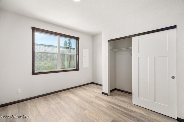 8 Potlatch Loop, Priest River, ID 83856 - unfurnished bedroom with light wood finished floors and a closet
