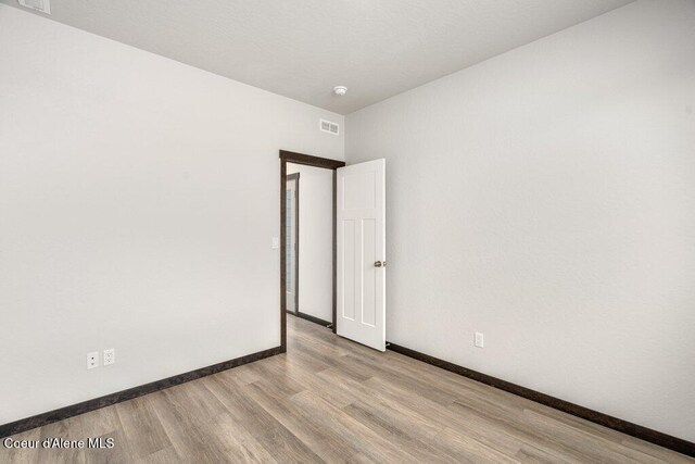 8 Potlatch Loop, Priest River, ID 83856 - empty room featuring wood finished floors and a smoke detector