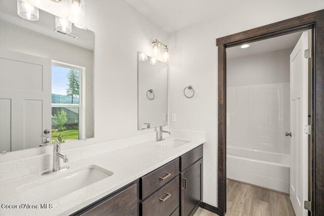 8 Potlatch Loop, Priest River, ID 83856 - bathroom with wood finished floors, double vanity, and bathing tub / shower combination