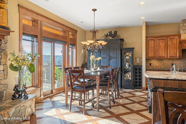 5841 W Clemetson Rd, Coeur Dalene, ID 83814 - dining space with plenty of natural light, wine cooler, recessed lighting, inlaid floor details, and a chandelier