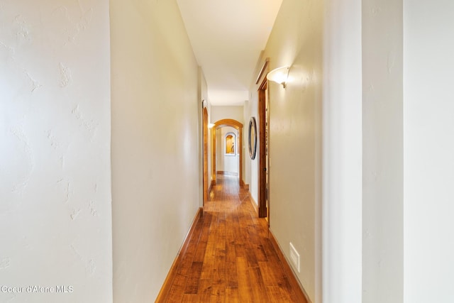 5841 W Clemetson Rd, Coeur Dalene, ID 83814 - hallway with arched walkways and wood-type flooring