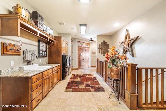 5841 W Clemetson Rd, Coeur Dalene, ID 83814 - kitchen with washing machine and clothes dryer and light stone countertops