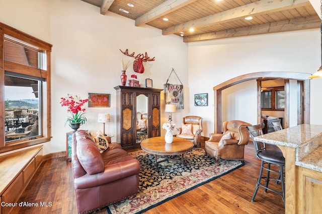 5841 W Clemetson Rd, Coeur Dalene, ID 83814 - living area with arched walkways, a wooden ceiling with exposed beams, hardwood / wood-style floors, and a high ceiling