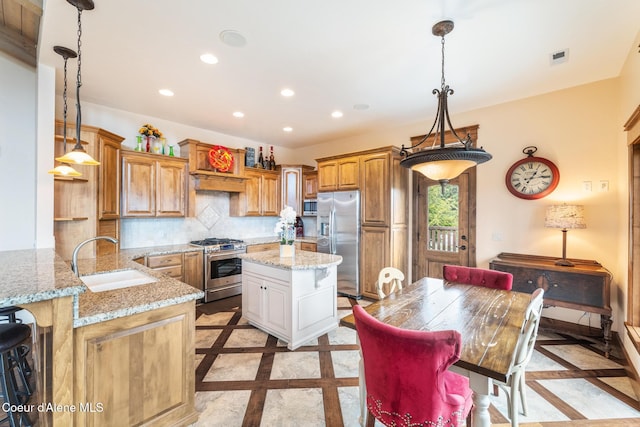 5841 W Clemetson Rd, Coeur Dalene, ID 83814 - kitchen featuring inlaid floor details, appliances with stainless steel finishes, recessed lighting, light stone counters, and tasteful backsplash