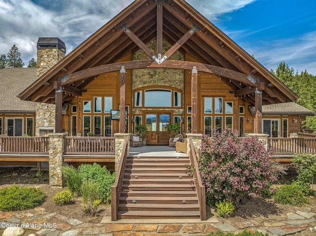 5841 W Clemetson Rd, Coeur Dalene, ID 83814 - view of front of home with a chimney, stone siding, stairs, and roof with shingles