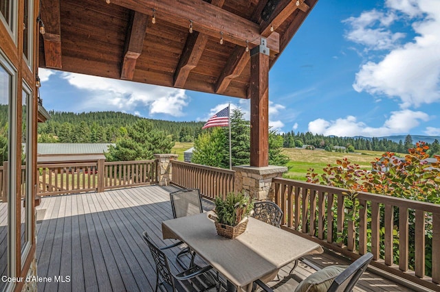 5841 W Clemetson Rd, Coeur Dalene, ID 83814 - wooden terrace featuring a mountain view, a wooded view, and outdoor dining space