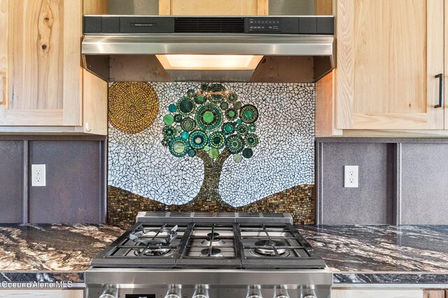 64 Heights Loop, Bonners Ferry, ID 83805 - kitchen with range, tasteful backsplash, under cabinet range hood, and light brown cabinetry