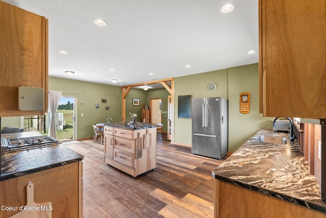 64 Heights Loop, Bonners Ferry, ID 83805 - kitchen with appliances with stainless steel finishes, dark wood finished floors, recessed lighting, and an island with sink