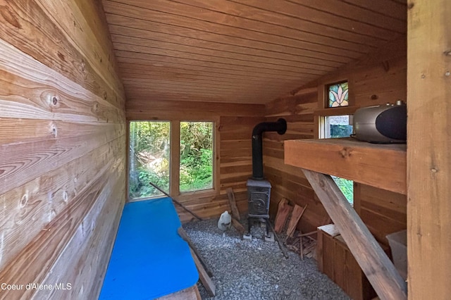 1283 N Wrenco Rd, Sandpoint, ID 83864 - interior space featuring wooden walls, wooden ceiling, and a wood stove