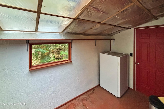 1283 N Wrenco Rd, Sandpoint, ID 83864 - basement with a textured wall and refrigerator