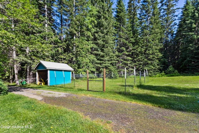 1283 N Wrenco Rd, Sandpoint, ID 83864 - view of yard with a storage unit and a view of trees