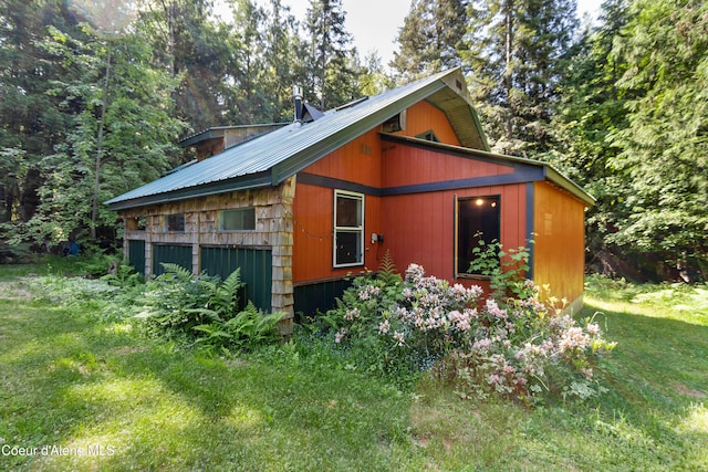 1283 N Wrenco Rd, Sandpoint, ID 83864 - view of property exterior with a metal roof and a lawn