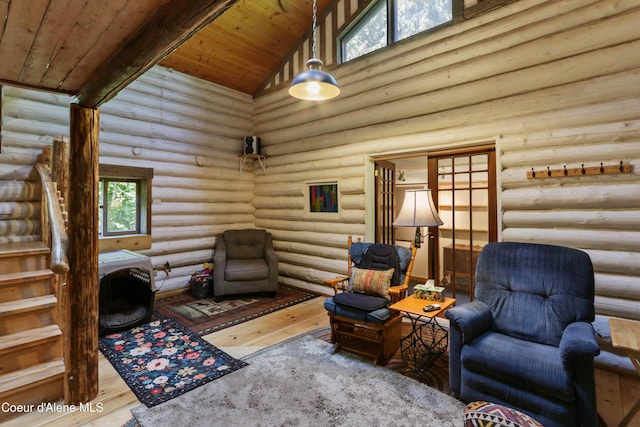 1283 N Wrenco Rd, Sandpoint, ID 83864 - living area featuring rustic walls, wood-type flooring, wood ceiling, high vaulted ceiling, and stairs
