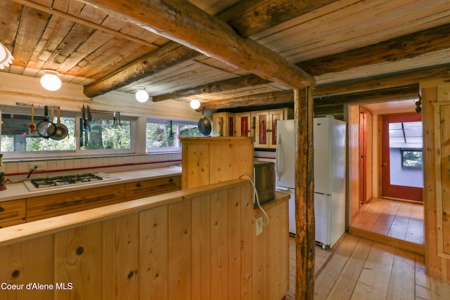 1283 N Wrenco Rd, Sandpoint, ID 83864 - kitchen with freestanding refrigerator, a wood ceiling with exposed beams, plenty of natural light, light wood-style flooring, and gas cooktop