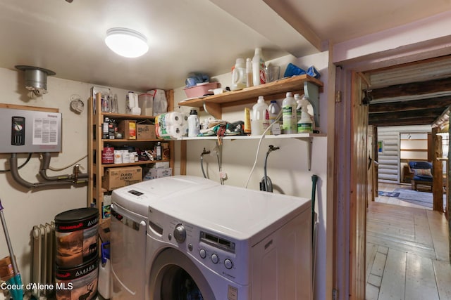 1283 N Wrenco Rd, Sandpoint, ID 83864 - washroom with water heater, radiator, washing machine and clothes dryer, and hardwood / wood-style floors