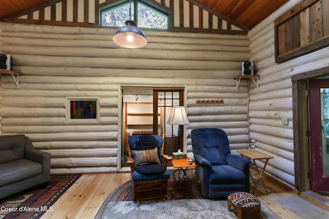 1283 N Wrenco Rd, Sandpoint, ID 83864 - living room featuring rustic walls, wood-type flooring, high vaulted ceiling, and wooden ceiling