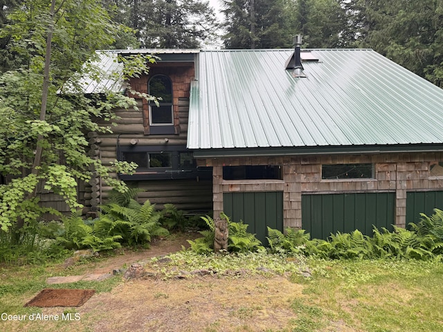 1283 N Wrenco Rd, Sandpoint, ID 83864 - view of side of home with a metal roof and log exterior