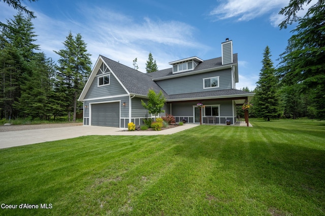 11683 E Whitetail Dr, Athol, ID 83801 - view of front facade with a porch, concrete driveway, a chimney, a front yard, and a shingled roof
