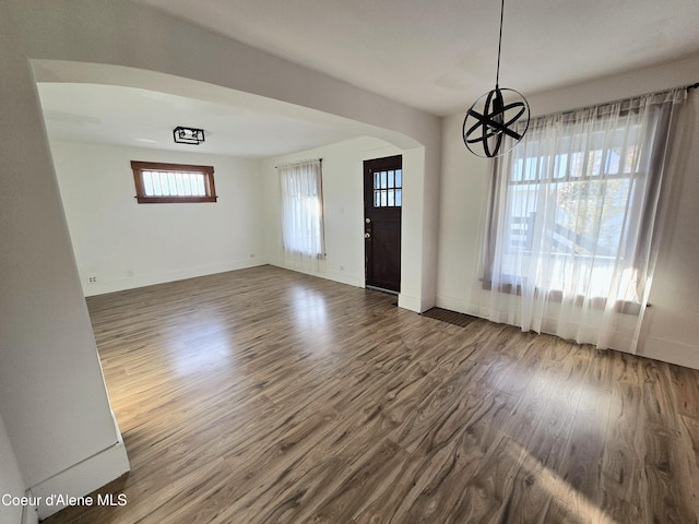 312 Park St, Mullan, ID 83846 - foyer featuring dark wood finished floors, arched walkways, and a chandelier