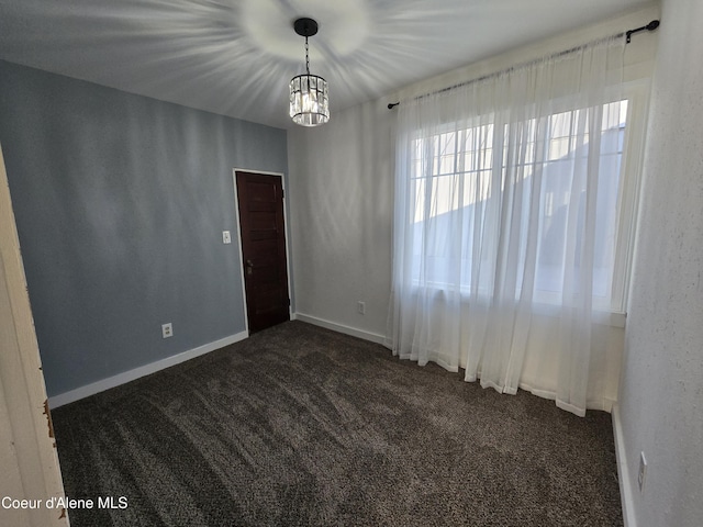 312 Park St, Mullan, ID 83846 - empty room featuring dark colored carpet and a chandelier