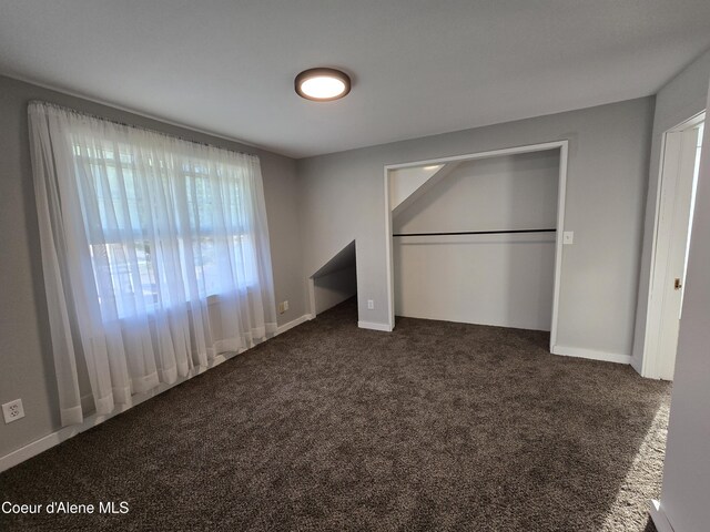 312 Park St, Mullan, ID 83846 - unfurnished bedroom featuring dark carpet and a closet