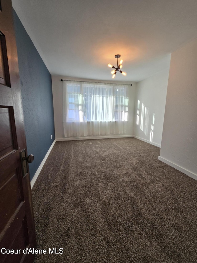 312 Park St, Mullan, ID 83846 - unfurnished room with carpet and a chandelier