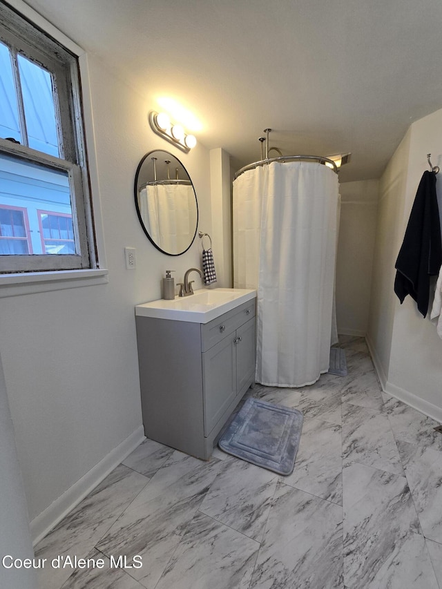312 Park St, Mullan, ID 83846 - full bathroom featuring marble finish floors, vanity, and a shower with curtain