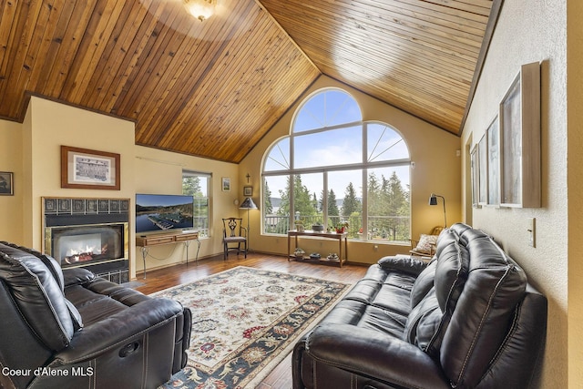7605 W Sanders Rd, Coeur Dalene, ID 83814 - living room featuring wooden ceiling, high vaulted ceiling, wood finished floors, and a tile fireplace