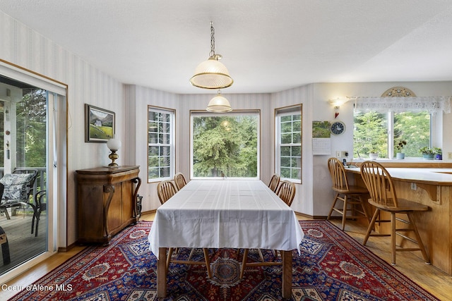 7605 W Sanders Rd, Coeur Dalene, ID 83814 - dining room featuring wood finished floors and wallpapered walls