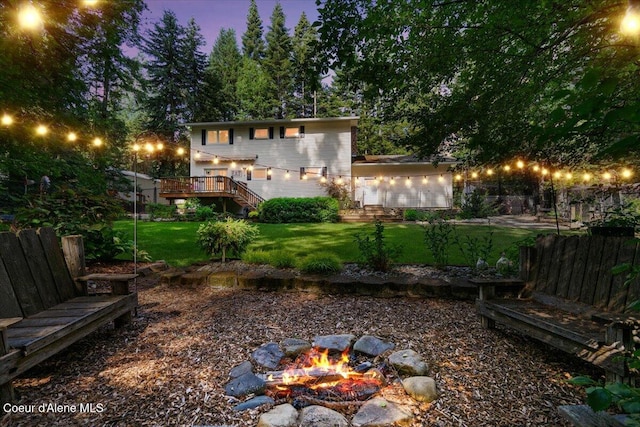 12321 N Sherwood Ct, Hayden, ID 83835 - view of yard featuring an outdoor fire pit, stairs, and a deck