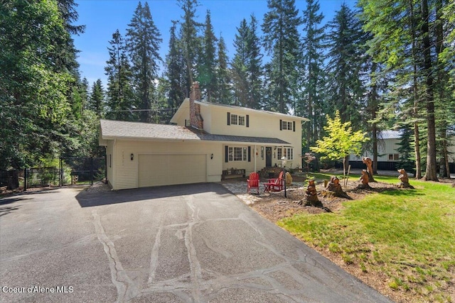 12321 N Sherwood Ct, Hayden, ID 83835 - traditional-style house featuring asphalt driveway and an attached garage