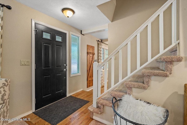 12321 N Sherwood Ct, Hayden, ID 83835 - foyer entrance with stairway, wood finished floors, and a textured ceiling