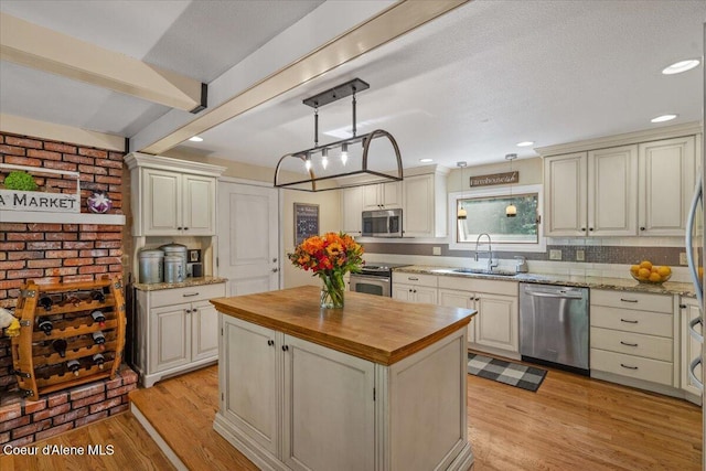 12321 N Sherwood Ct, Hayden, ID 83835 - kitchen with stainless steel appliances, butcher block counters, a center island, light wood-style flooring, and recessed lighting